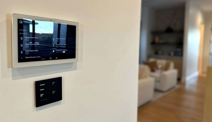 A wall-mounted smart home touchscreen control panel for home automation.